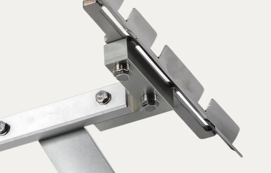 Close-up of a metal bracket with bolts and a serrated-edge design, suggesting functionality and industrial precision, against a plain background.