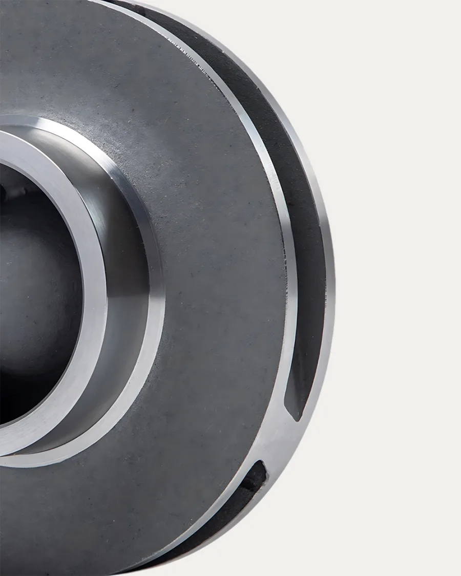 Close-up of a metallic, circular industrial component with grooved edges and smooth, polished surfaces. The image conveys a technical and precise tone.